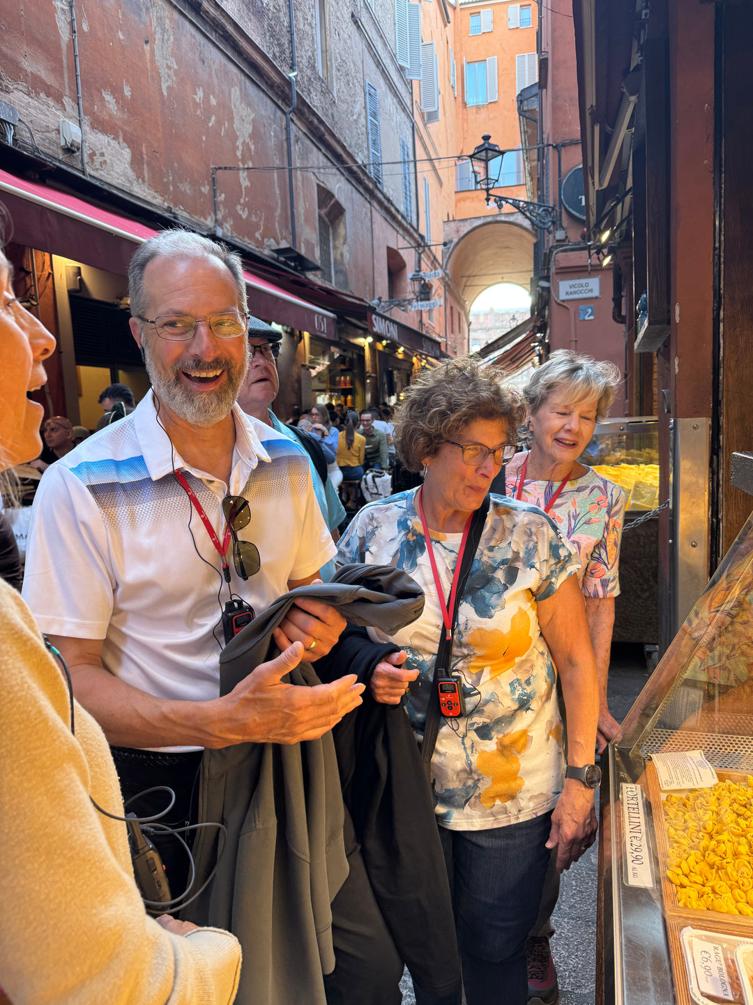 Smiling group of travellers on a narrow market street