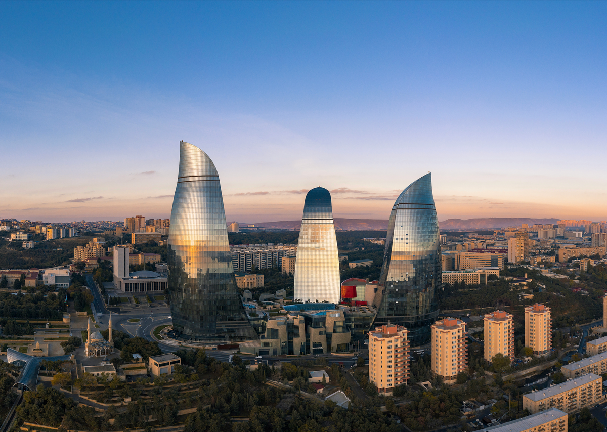Baku Flame Towers rising above the city at sunset