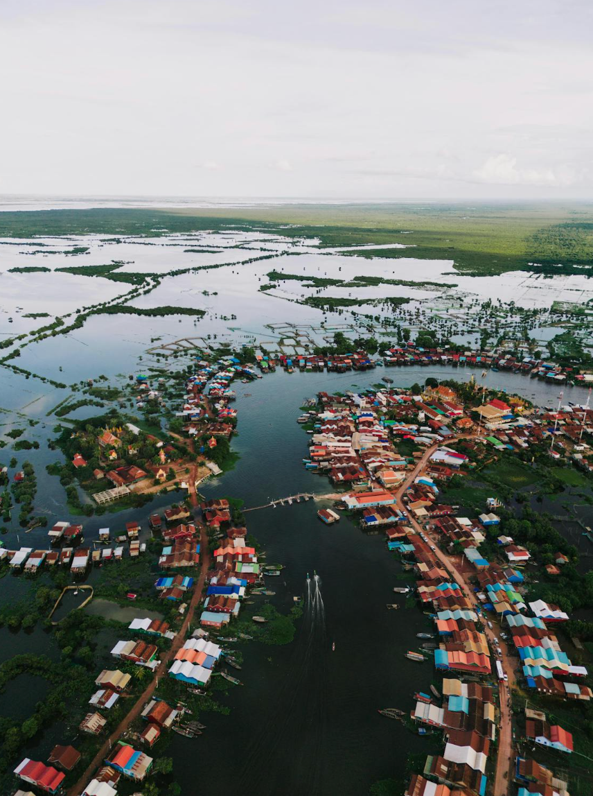 Aerial view of a village of stilt houses surrounded by floodwater