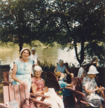 Vintage photo of older women relaxing in chairs by a lake