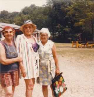 Vintage photo of three older women in sun hats standing outdoors