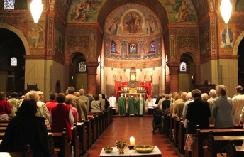 Congregation seated in an ornate church with painted ceilings