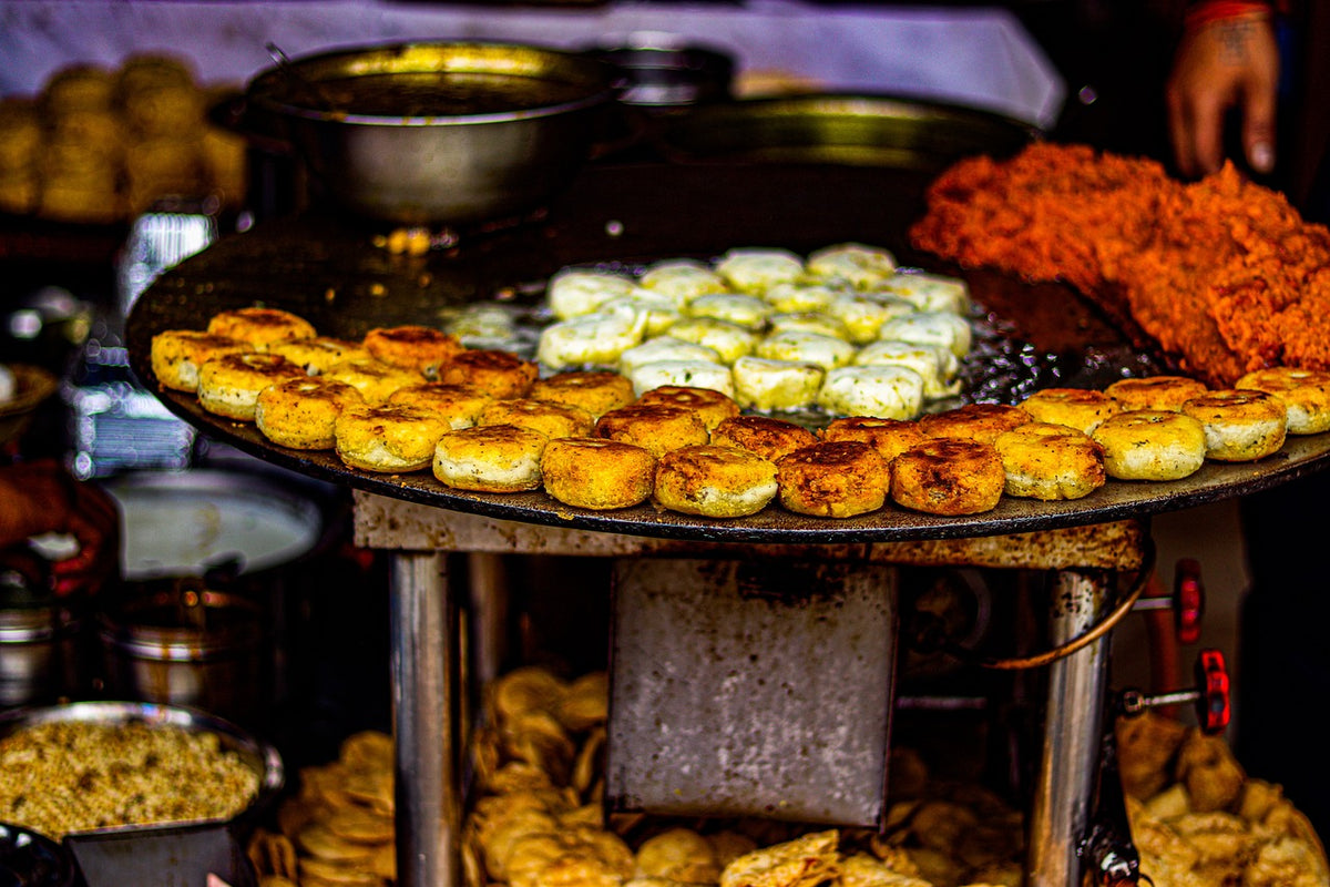 Street stall of fried sweets and snacks on large trays