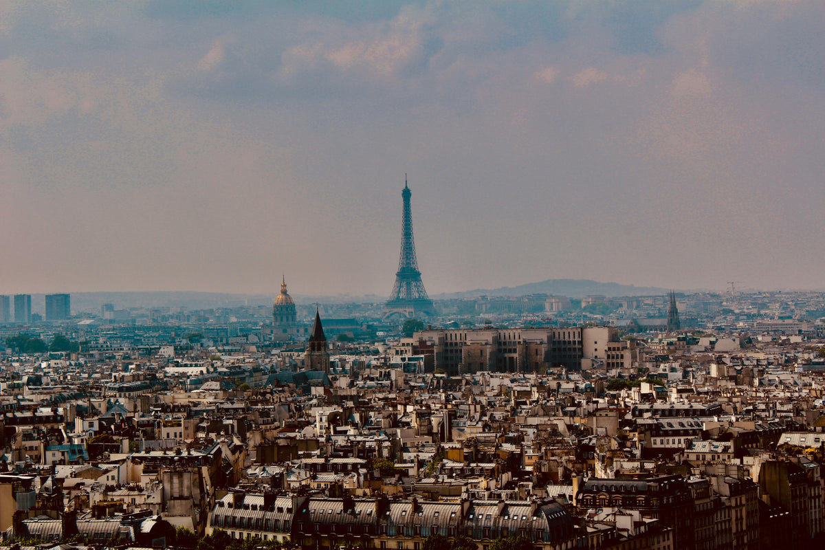 City skyline at dusk with the Eiffel Tower on the horizon