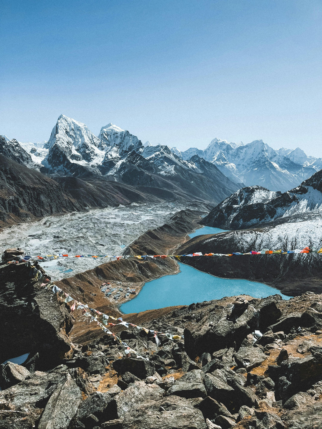 Turquoise glacial lake beneath snowy mountain peaks