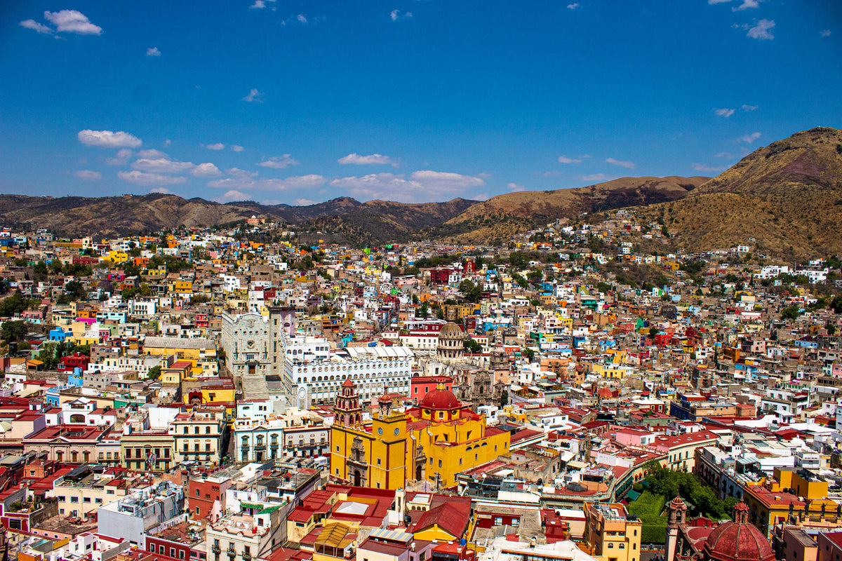Hillside city of colourful houses around a yellow church