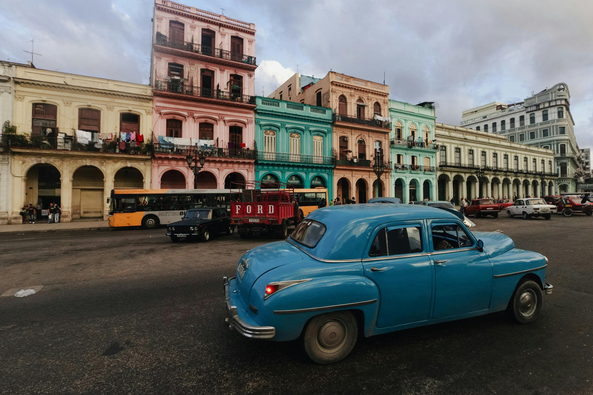 Vintage blue car on a street of colourful colonial buildings