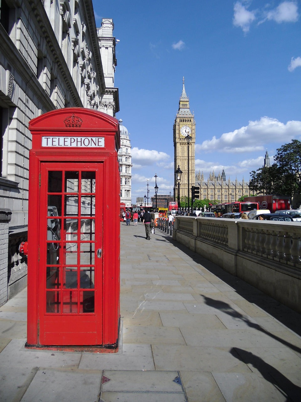 Red telephone box on a London street with Big Ben behind