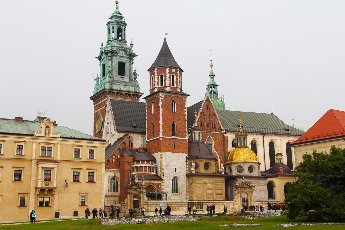 Hilltop castle and cathedral with green and gold domed towers