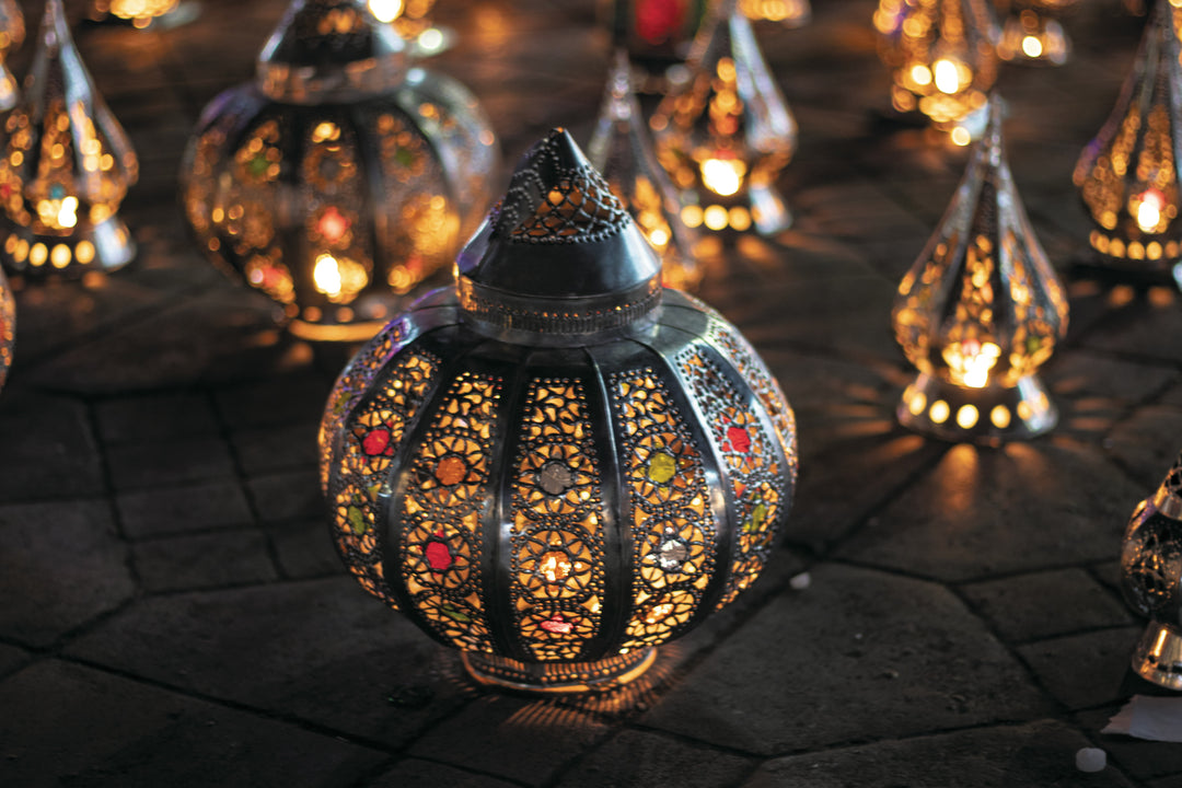 Ornate metal lanterns glowing on a patterned tile floor