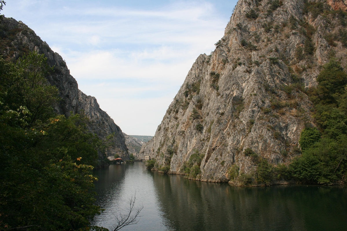 Calm river winding through a steep rocky canyon